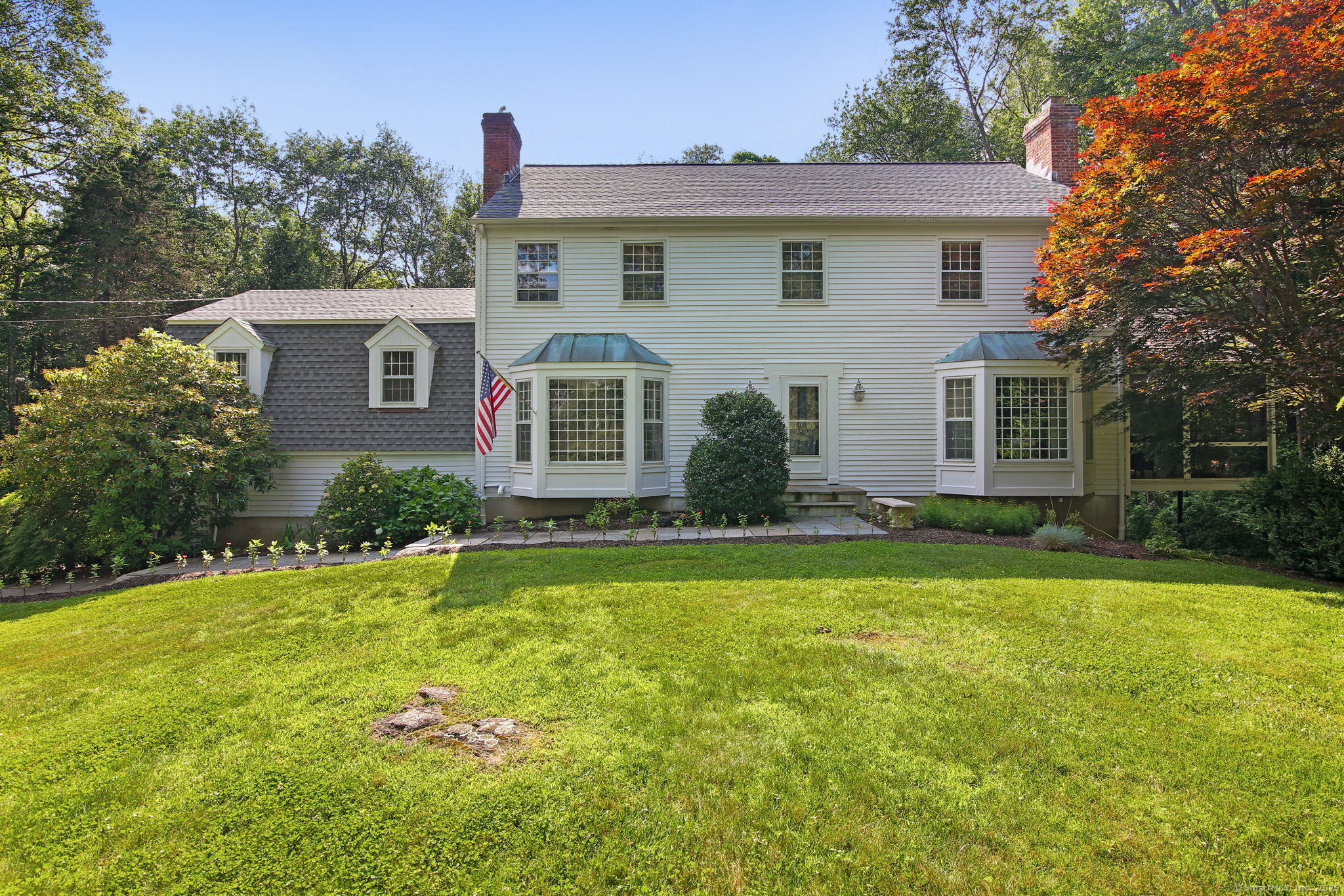 63 Pipers Hill Road Wilton, CT 06897 - Photo 3 of 37 a front view of house with yard and green space