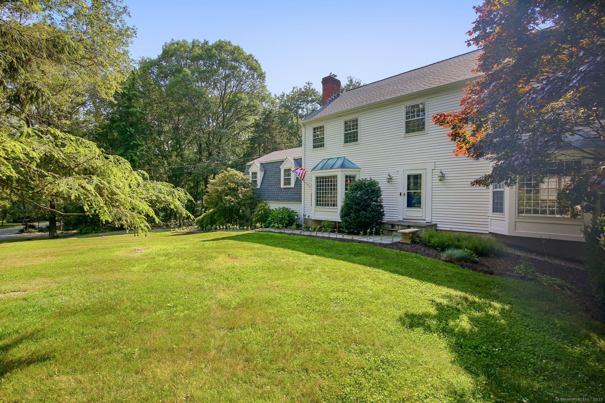 63 Pipers Hill Road Wilton, CT 06897 - Photo 34 of 37 a front view of house with yard and green space