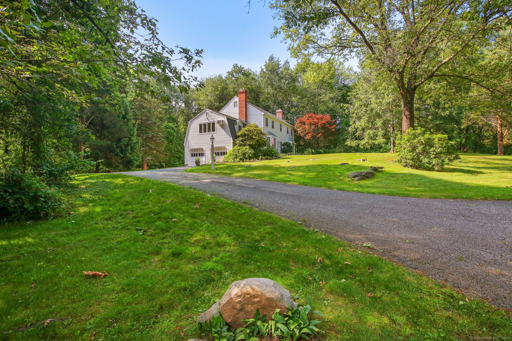 63 Pipers Hill Road Wilton, CT 06897 - Photo 36 of 37 a view of a house with a yard and large trees