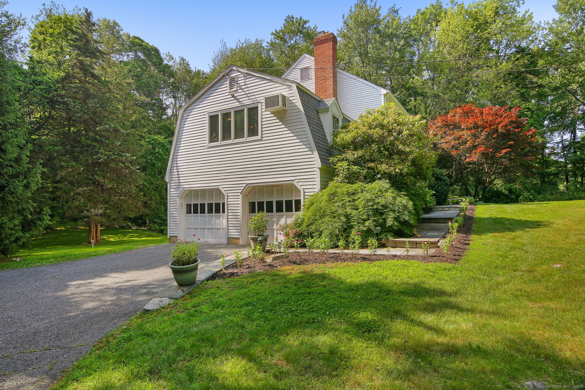 63 Pipers Hill Road Wilton, CT 06897 - Photo 5 of 37 a front view of a house with garden