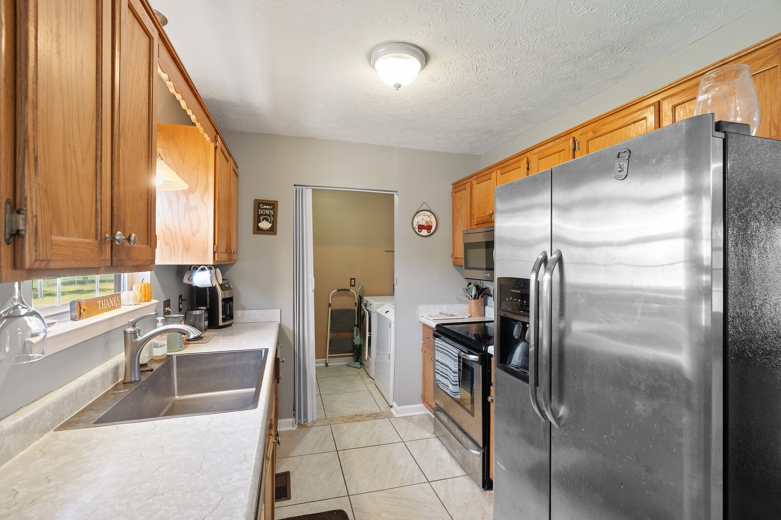 155 Smith Road Portland, TN 37148 - Photo 8 of 24 a kitchen with a refrigerator a sink and a large window
