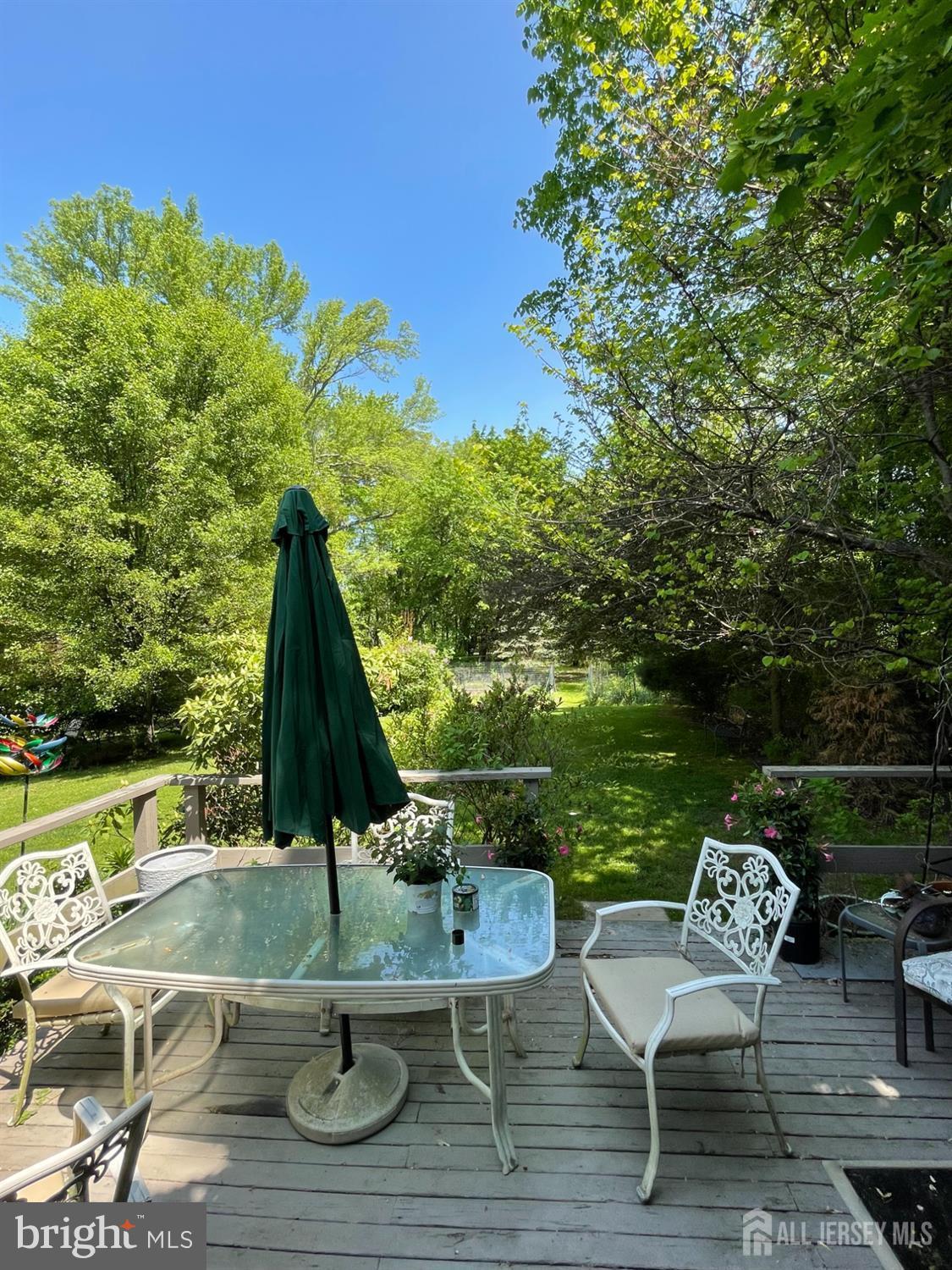181 Disbrow Hill Road Monroe Township, NJ 08831 - Photo 14 of 21 a view of a lake with couches and wooden floor