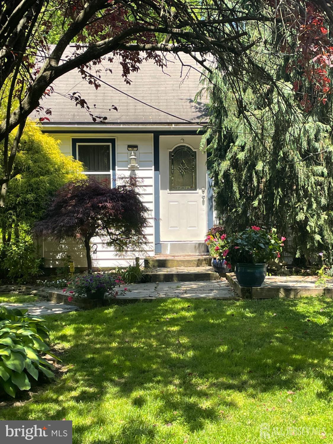 181 Disbrow Hill Road Monroe Township, NJ 08831 - Photo 2 of 21 a view of a white house with a big yard and potted plants