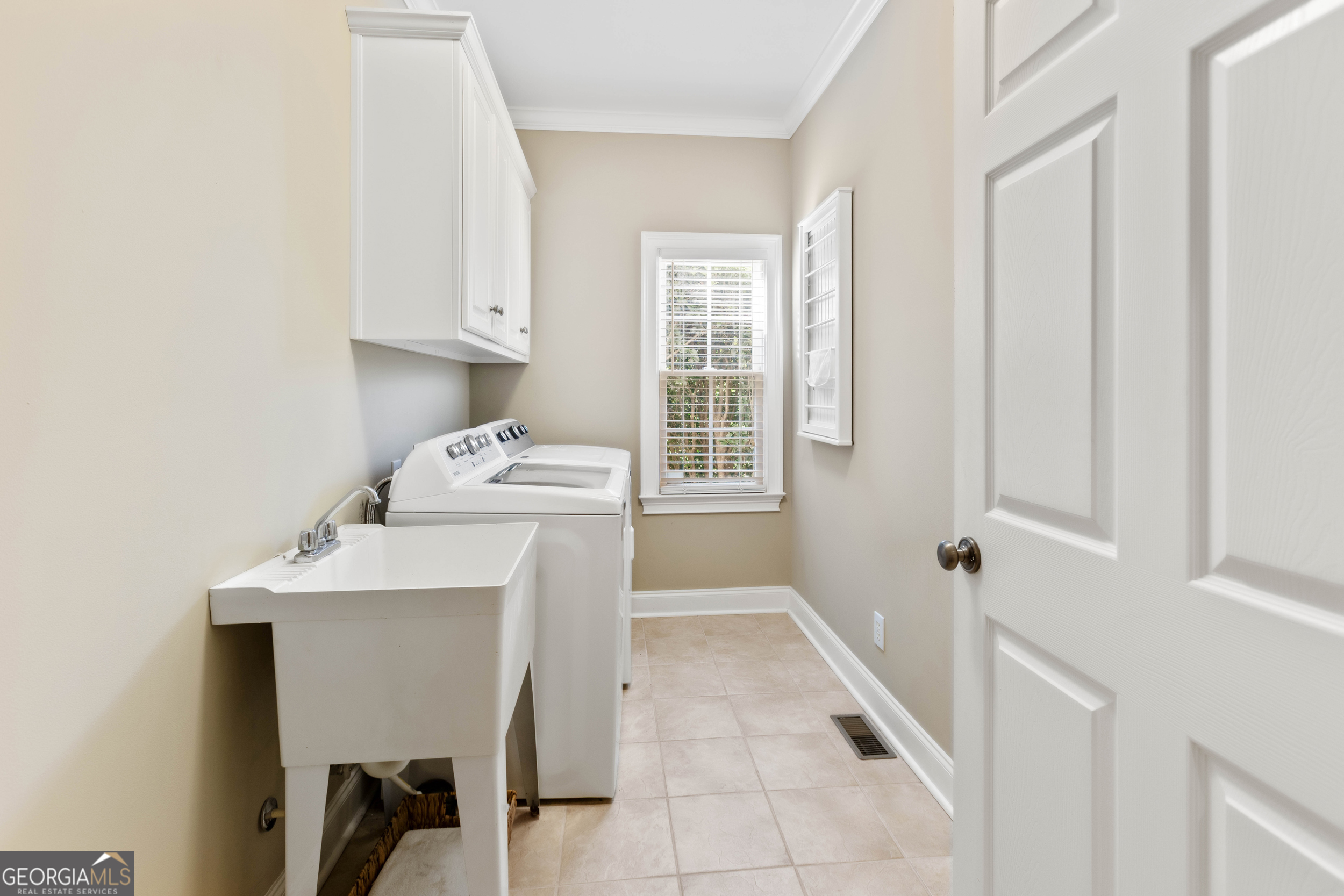 1030 Spring Lake Drive Bishop, GA 30621 - Photo 28 of 53 a utility room with cabinets washer and dryer