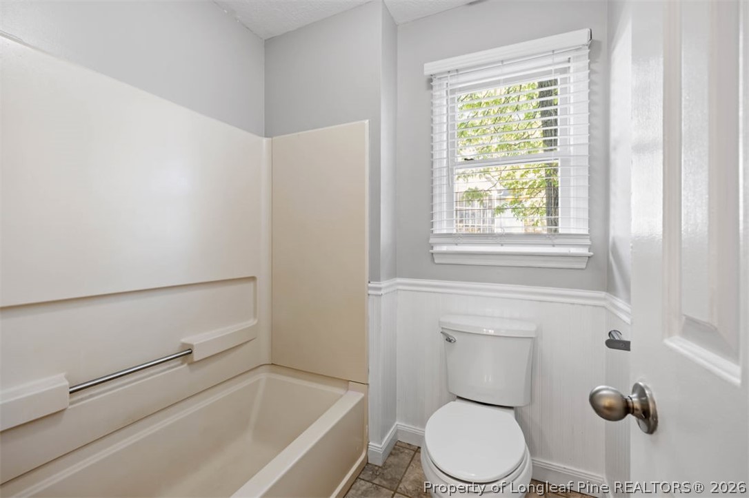 1205 Crossbend Court Fayetteville, NC 28314 - Photo 22 of 37 a white toilet sitting next to a bath tub
