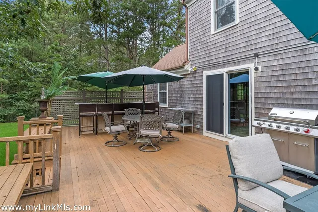 a view of a patio with table and chairs under an umbrella