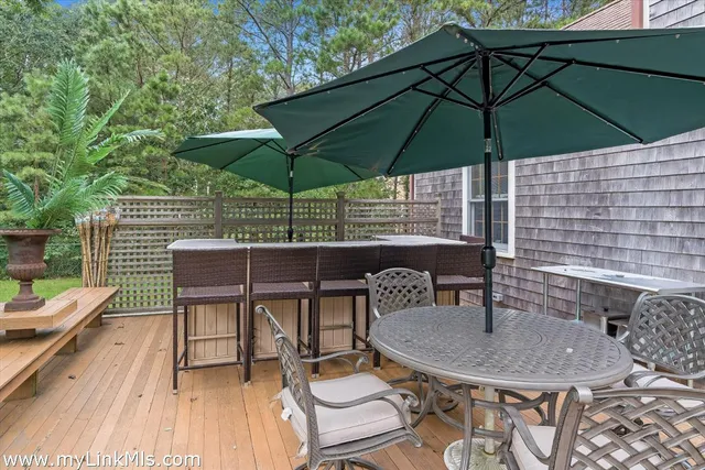 a patio with a table and chairs under an umbrella