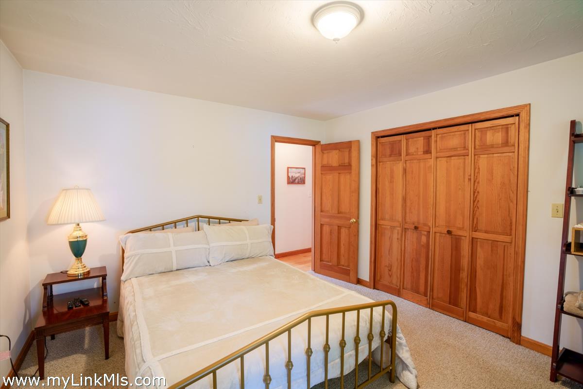 2 Farm Path Road Oak Bluffs, MA 02557 - Photo 17 of 37 a bedroom with a bed and a lamp