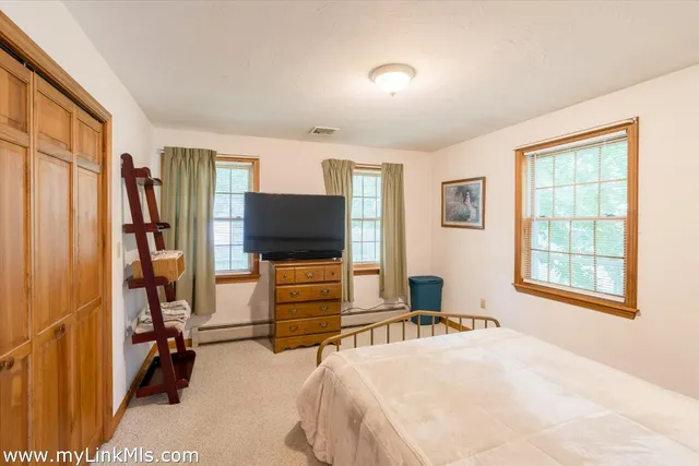 a bedroom with bed and tv