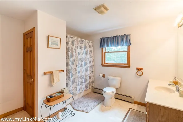 a bathroom with a toilet a sink and a shower