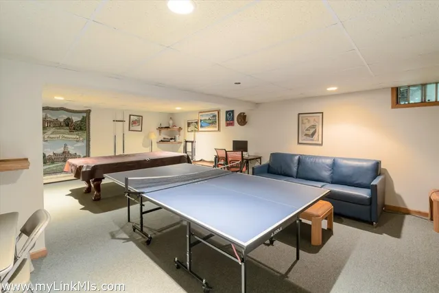 a room with furniture pool table and windows