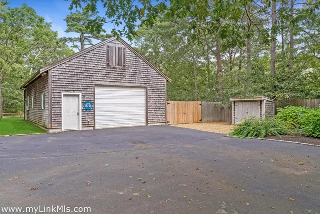 a view of a house with a yard and garage