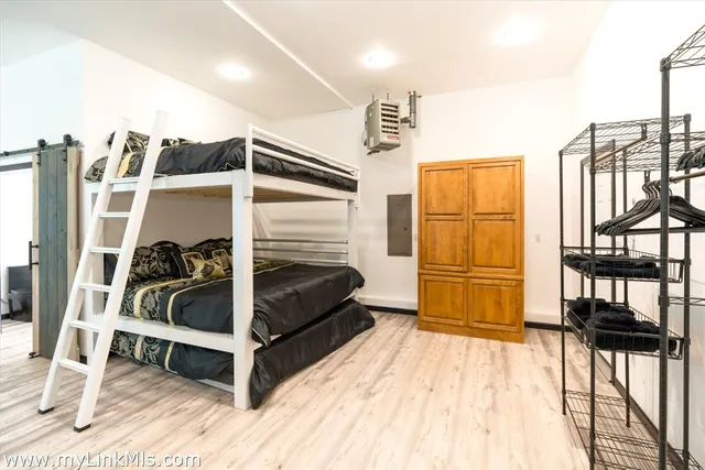 a bedroom with furniture and a window