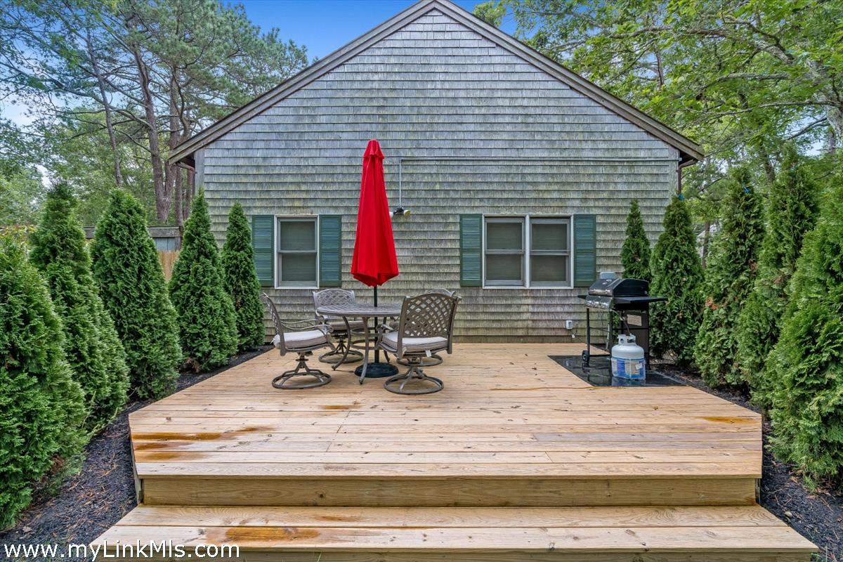 2 Farm Path Road Oak Bluffs, MA 02557 - Photo 37 of 37 a view of table and chairs in patio of the house
