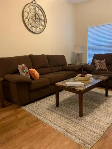 a living room with furniture a table and a potted plant