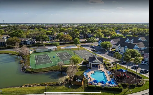 an aerial view of a house with a garden and lake view