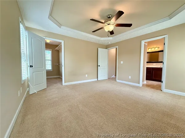 a view of a livingroom with a ceiling fan and window