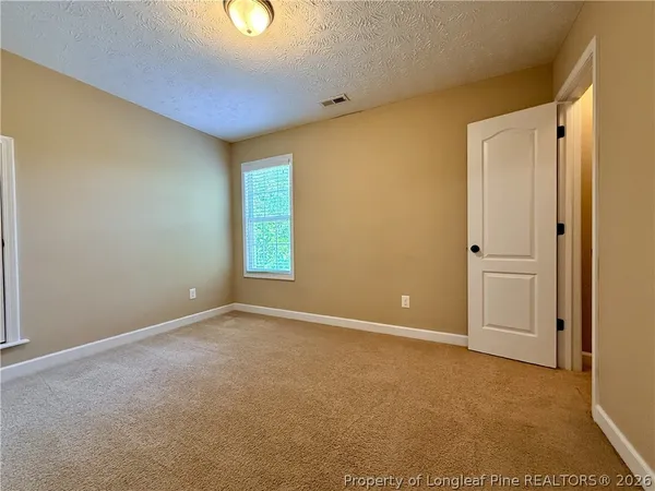 an empty room with closet area