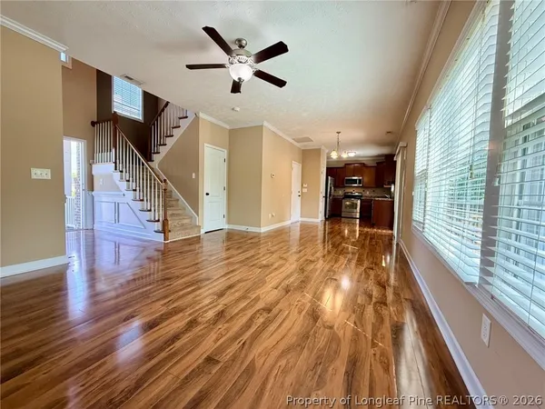 a view of entryway and kitchen with wooden floor