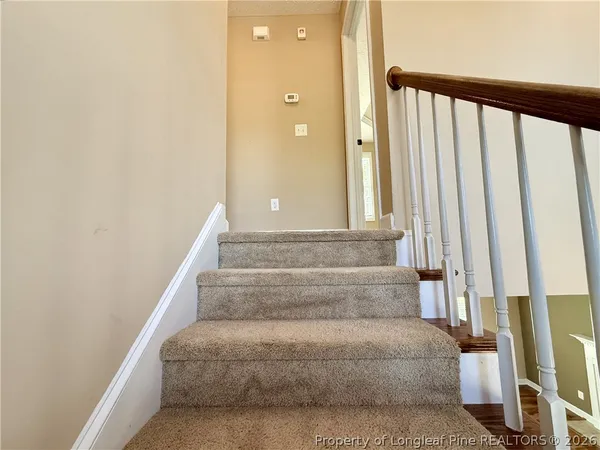 a view of staircase with white walls
