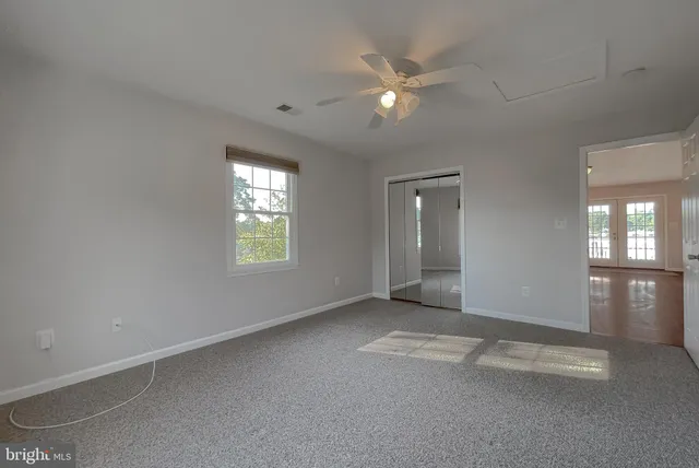a view of a swimming pool with lawn chairs under an umbrella