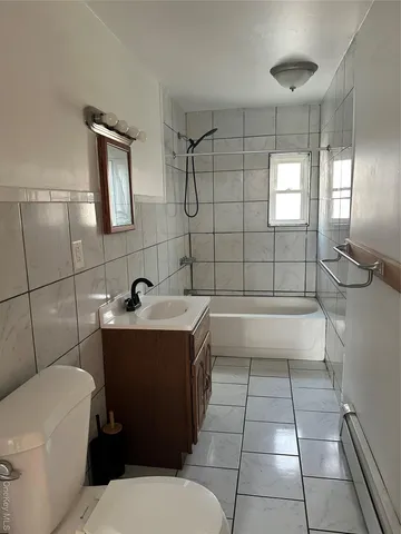a bathroom with a sink toilet and tub