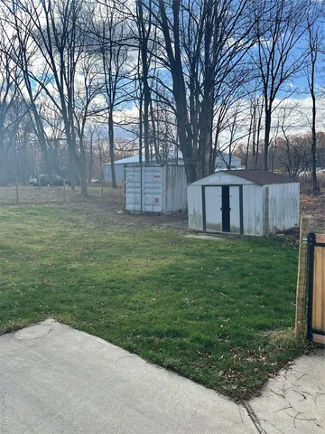 a view of a backyard with large trees