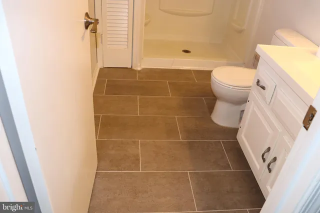 a bathroom with a glass shower door