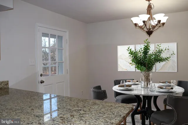 a kitchen with stainless steel appliances granite countertop wooden cabinets a sink and a dishwasher next to a window