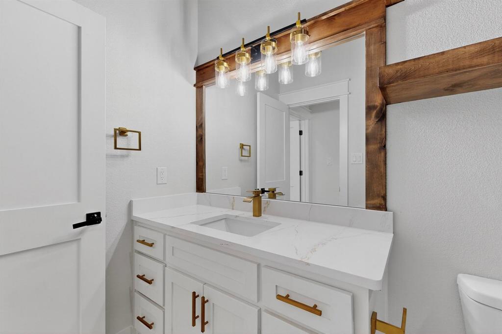 1161 Gonzollas Road Springtown, TX 76082 - Photo 30 of 40 a bathroom with a sink and a mirror