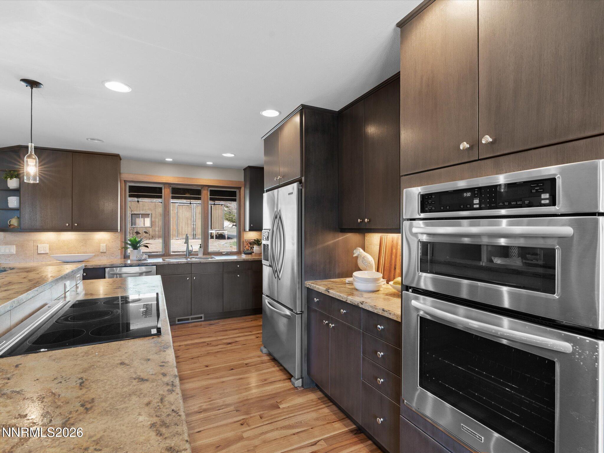 20 Connie Way Reno, NV 89521 - Photo 17 of 69 a kitchen with stainless steel appliances kitchen island granite countertop a stove a sink and a microwave