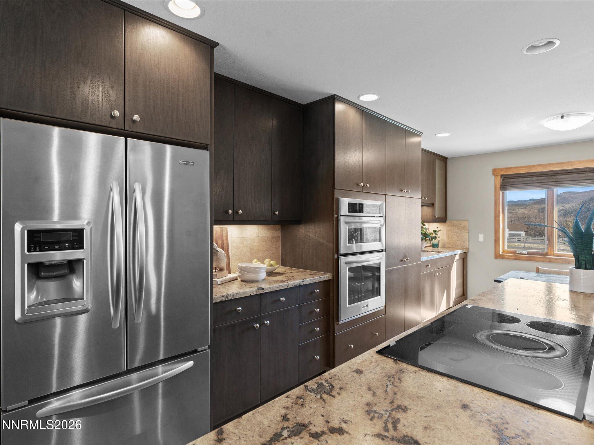 20 Connie Way Reno, NV 89521 - Photo 20 of 69 a kitchen with stainless steel appliances granite countertop a refrigerator and a stove top oven