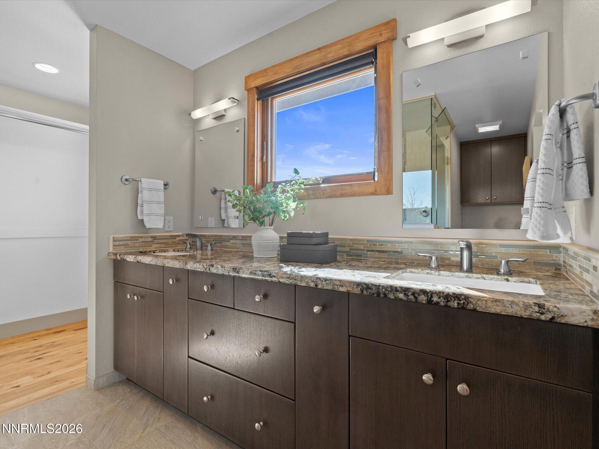 20 Connie Way Reno, NV 89521 - Photo 27 of 69 a bathroom with a granite countertop sink and a mirror