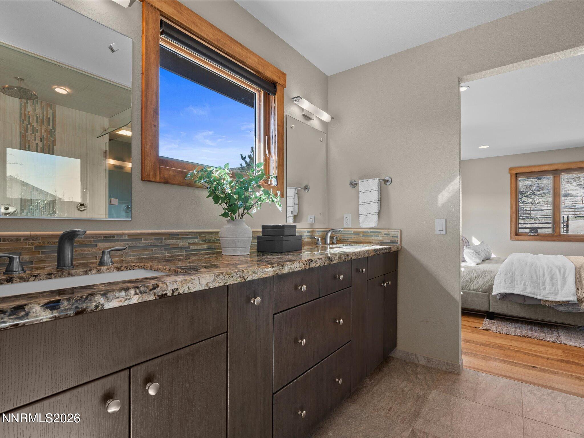 20 Connie Way Reno, NV 89521 - Photo 28 of 69 a en suite bathroom with a granite countertop sink and a mirror