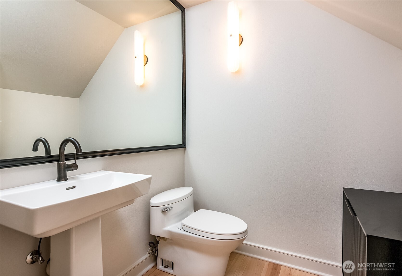 21 West Comstock Street, Unit 102 Seattle, WA 98119 - Photo 12 of 22 a bathroom with a sink a toilet and mirror