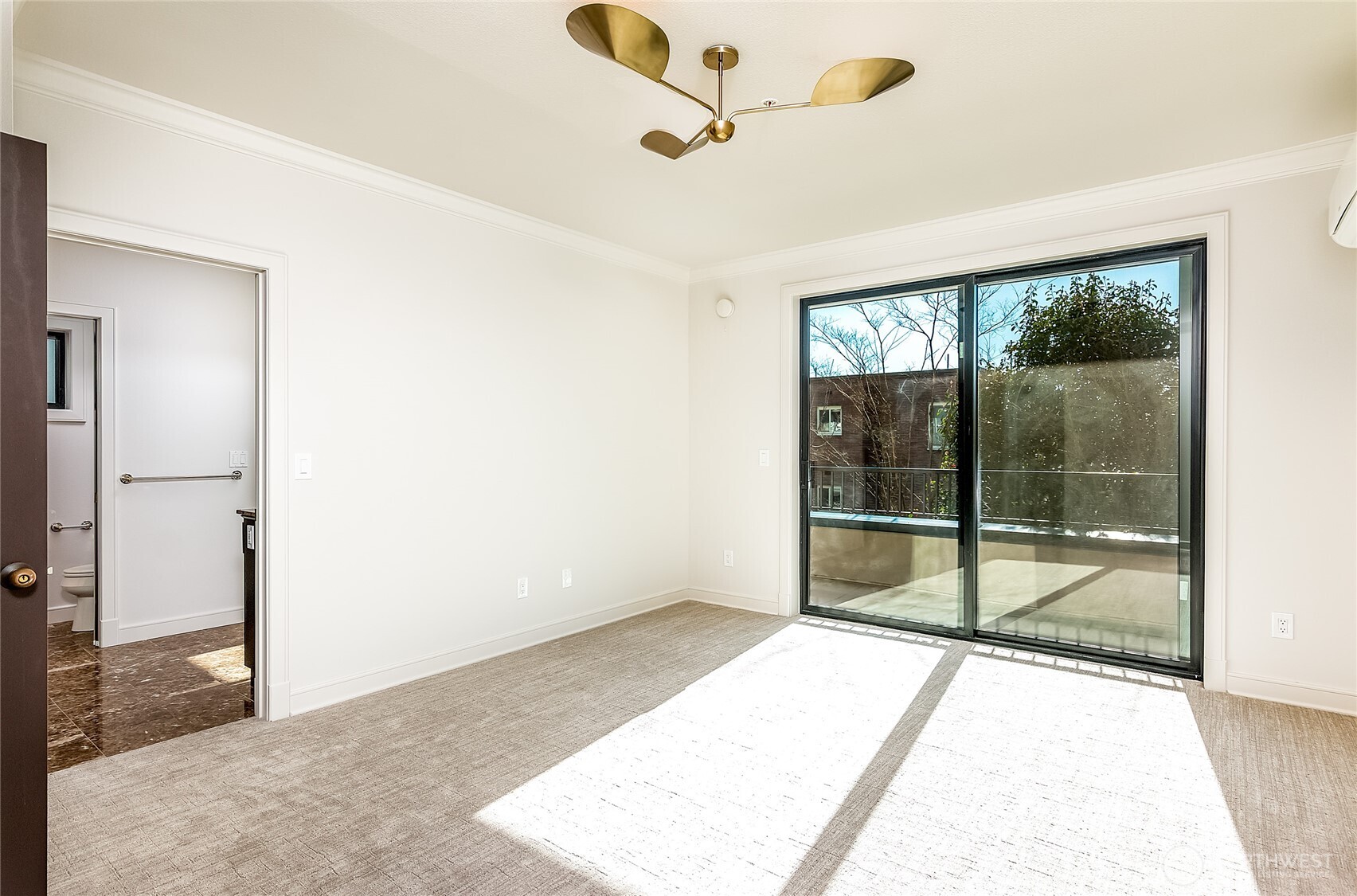 21 West Comstock Street, Unit 102 Seattle, WA 98119 - Photo 13 of 22 a view of an empty room with wooden floor and a window