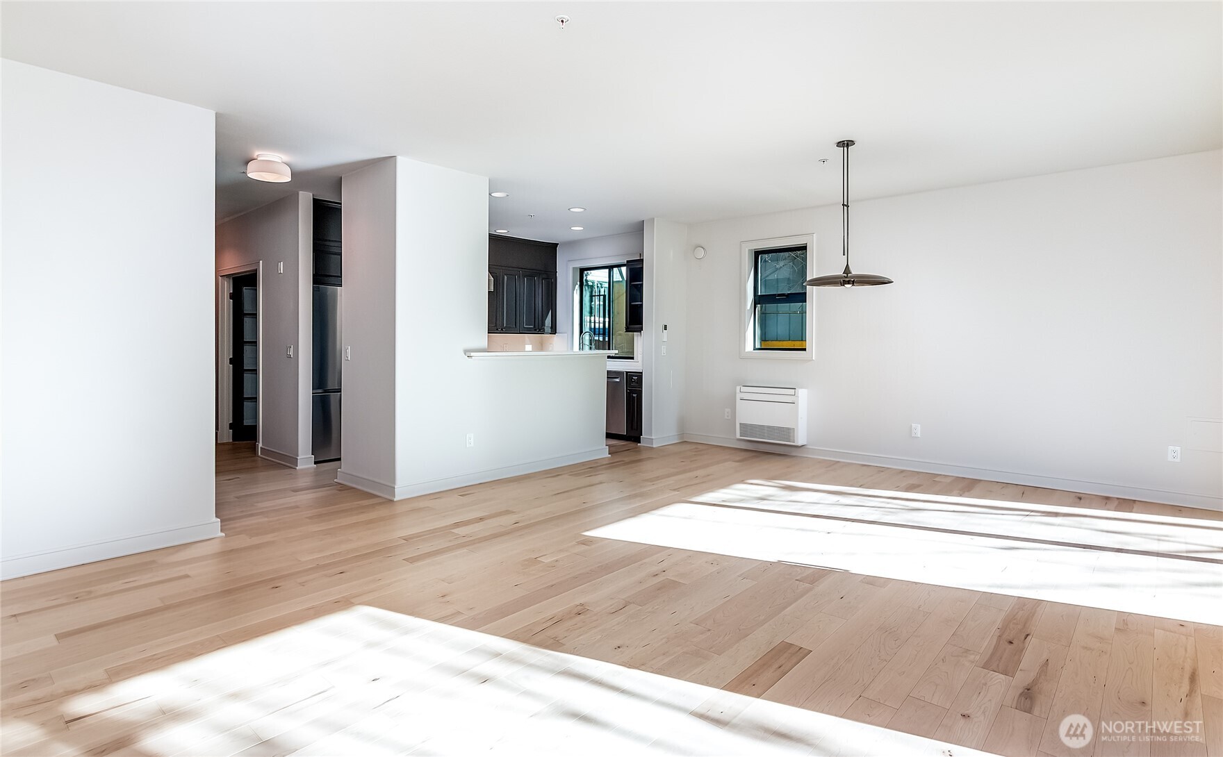 21 West Comstock Street, Unit 102 Seattle, WA 98119 - Photo 6 of 22 a view of a kitchen with a sink refrigerator and window