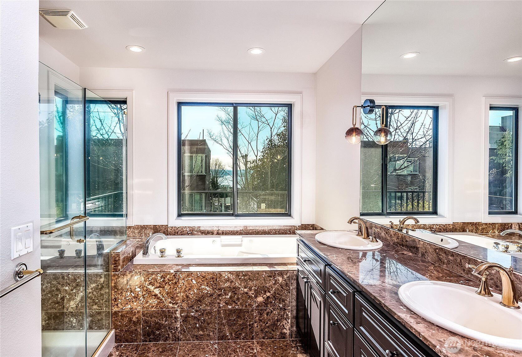 21 West Comstock Street, Unit 102 Seattle, WA 98119 - Photo 8 of 22 a bathroom with a granite countertop tub and a sink