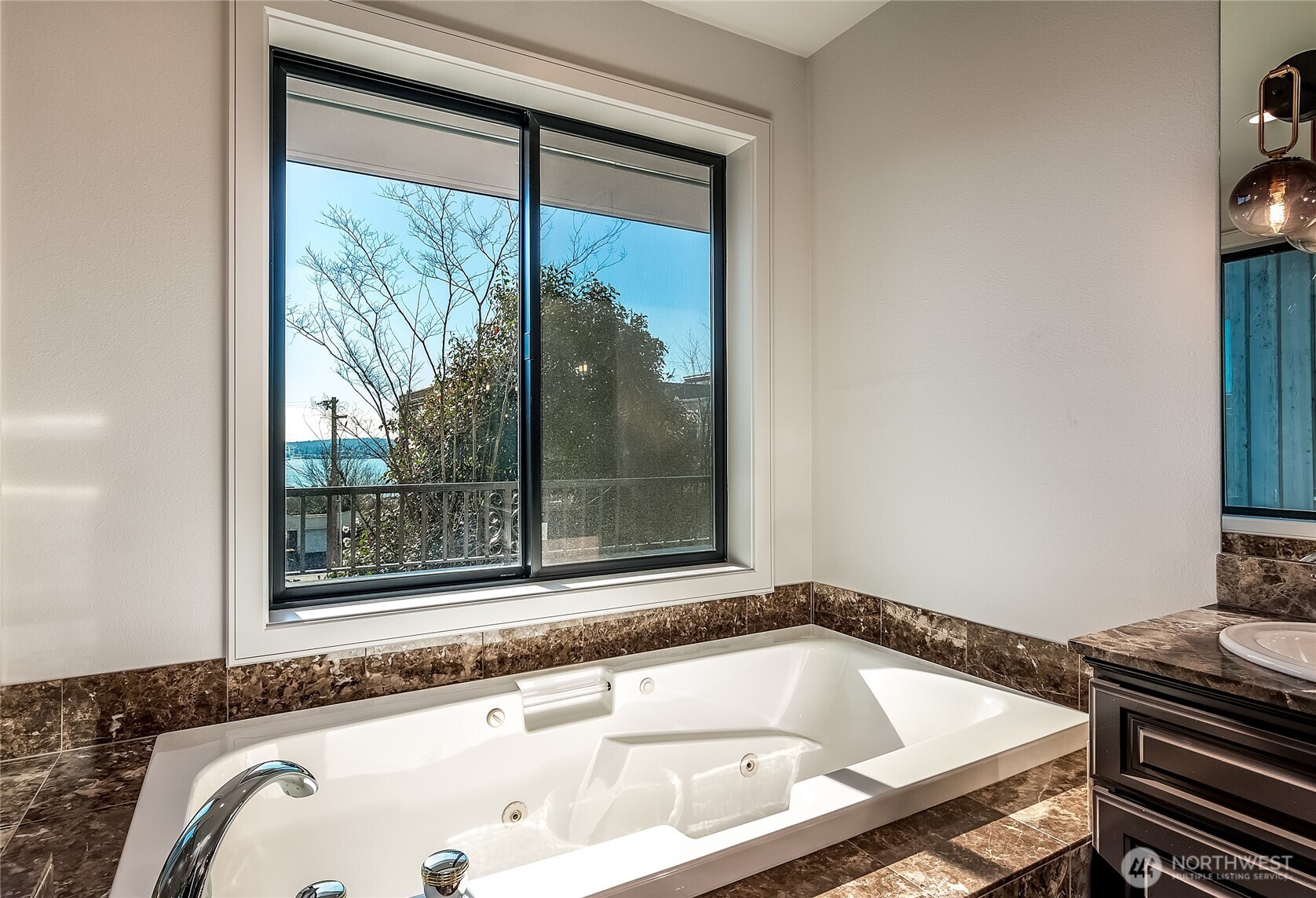 21 West Comstock Street, Unit 102 Seattle, WA 98119 - Photo 10 of 22 a bathroom with a tub and a window
