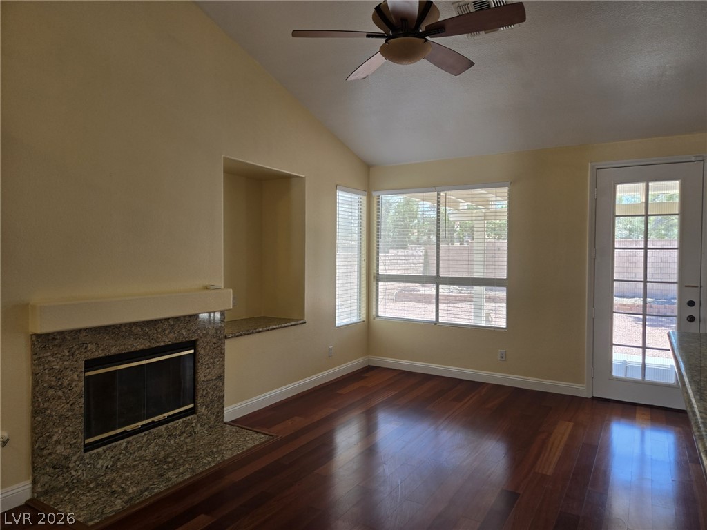 8417 San Ramon Drive Las Vegas, NV 89147 - Photo 8 of 33 Hardwood floors and a cozy fireplace define this inviting living area.