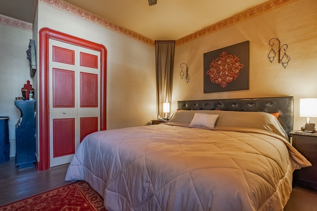 3853 North Main Street Fall River, MA 02720 - Photo 22 of 38 a bedroom with a bed and a lamp with wooden floor