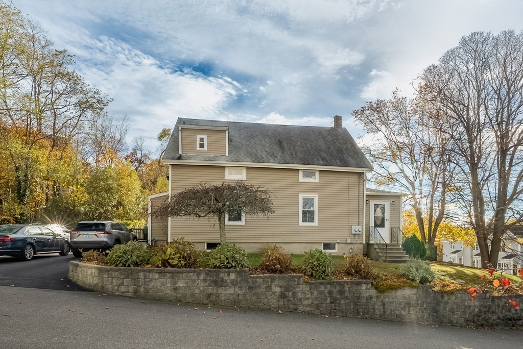 3853 North Main Street Fall River, MA 02720 - Photo 3 of 38 a front view of a house with a yard and garage