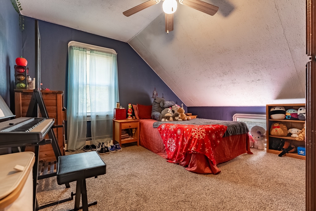3853 North Main Street Fall River, MA 02720 - Photo 37 of 38 a bed room with a bed and a chair