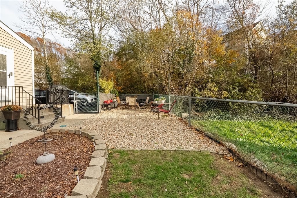 3853 North Main Street Fall River, MA 02720 - Photo 6 of 38 a view of swimming pool with a bench and trees in the background