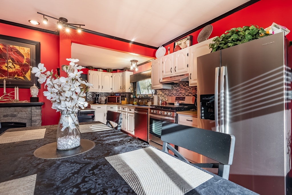 3853 North Main Street Fall River, MA 02720 - Photo 10 of 38 a living room with fireplace furniture and a potted plant