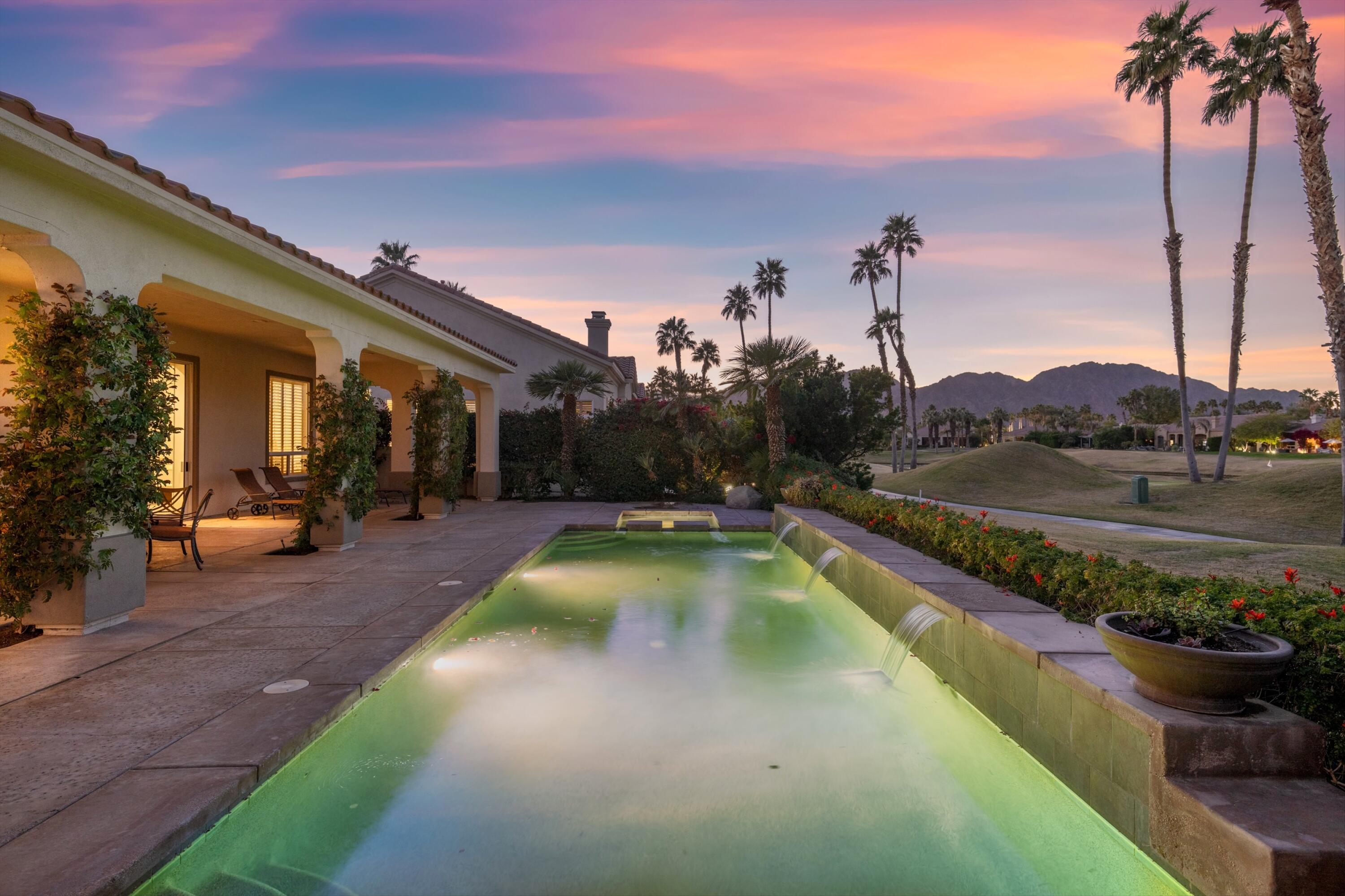 81100 Legends Way La Quinta, CA 92253 - Photo 1 of 37 a view of a swimming pool with a lounge chairs