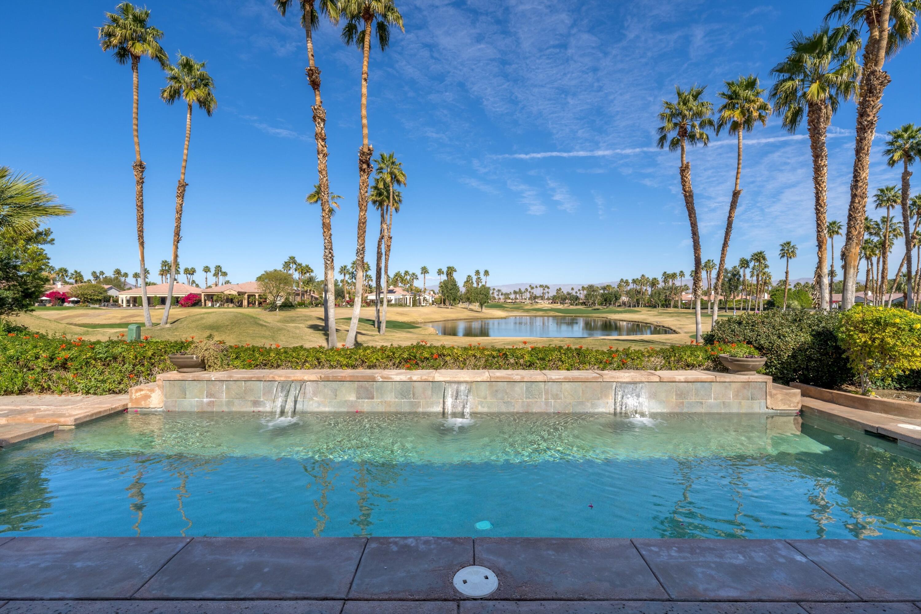 81100 Legends Way La Quinta, CA 92253 - Photo 12 of 37 a view of a swimming pool with a lawn chairs under an umbrella