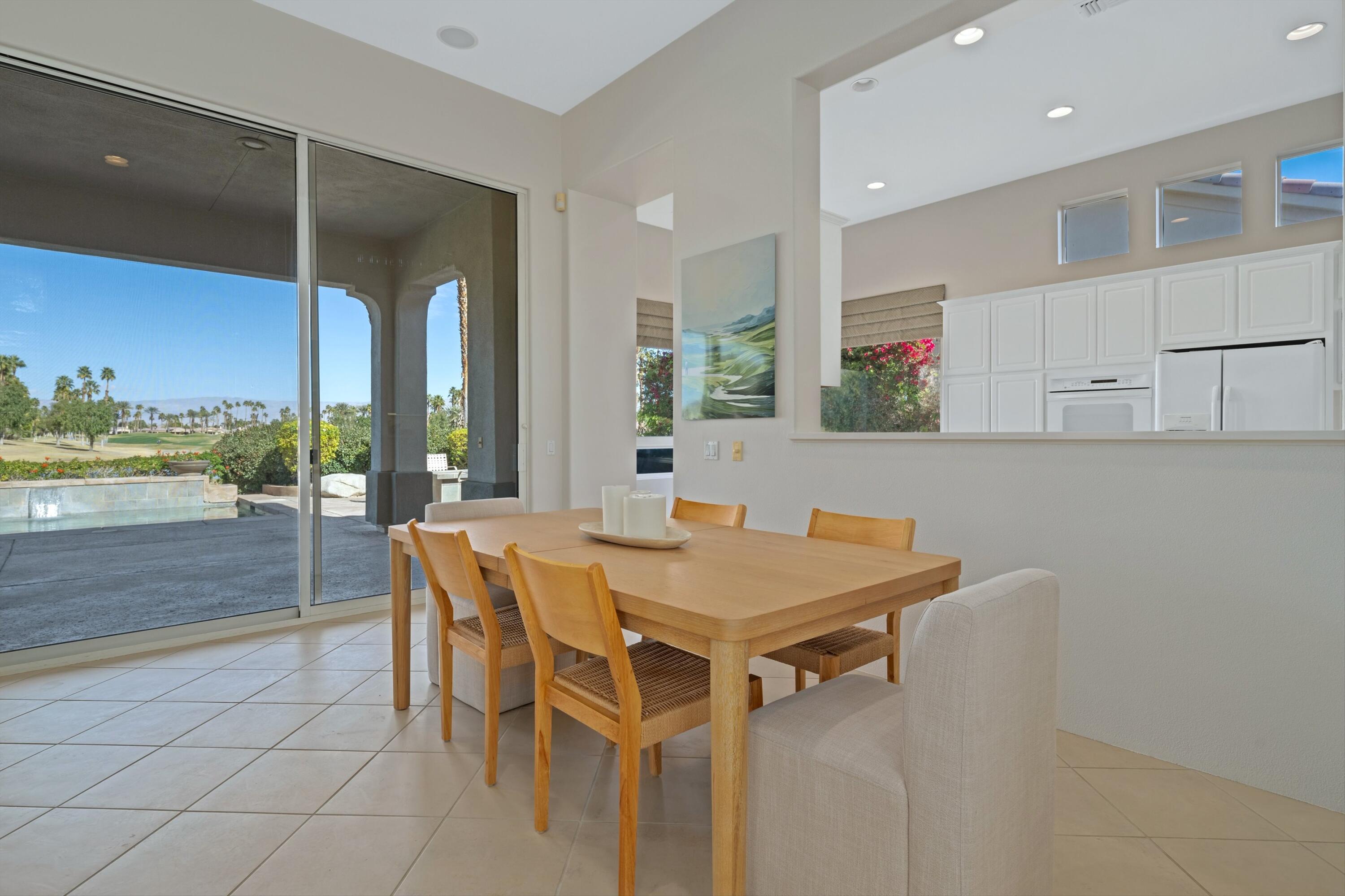 81100 Legends Way La Quinta, CA 92253 - Photo 20 of 37 a view of a dining room with furniture and a large window