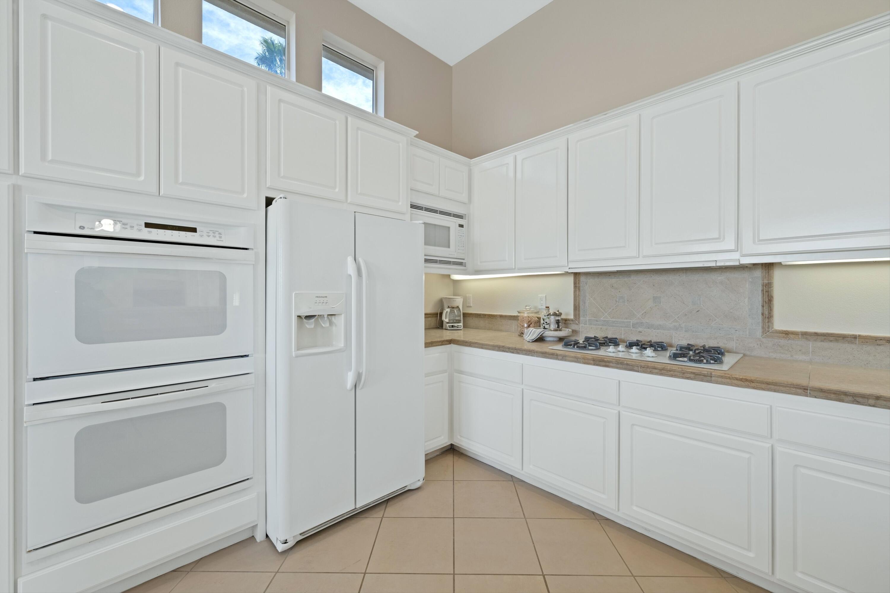 81100 Legends Way La Quinta, CA 92253 - Photo 23 of 37 a kitchen with granite countertop white cabinets and stainless steel appliances