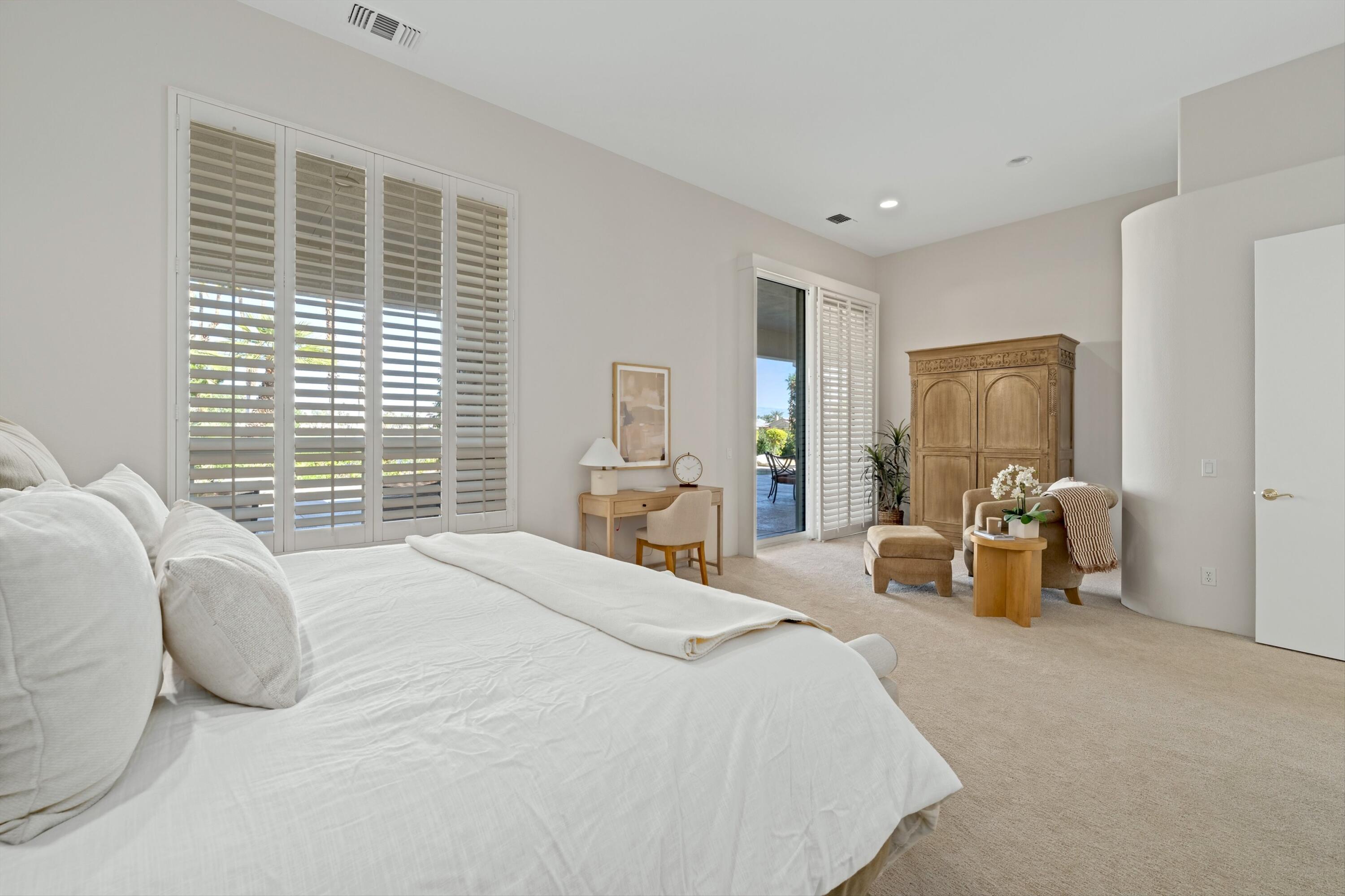 81100 Legends Way La Quinta, CA 92253 - Photo 29 of 37 a bedroom with furniture and a large window